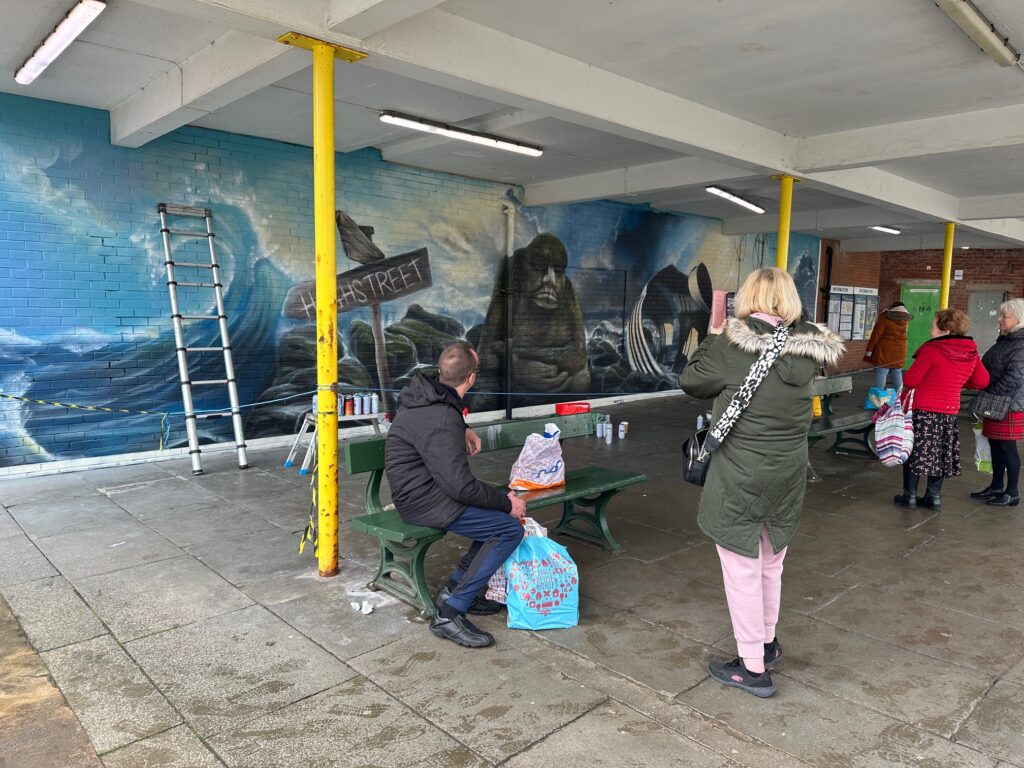 People enjoy watching the painting in progress